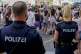 Police officers stand near gathering swifties in Vienna on A