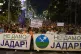 People hold banners reading, 