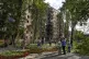 People gather at an apartment building damaged after shellin