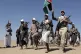 Houthi rebel fighters march during a rally of support for th