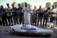 Palestinians pray next to the bodies of their relatives kill
