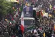 Iranians follow a truck carrying the coffins of Hamas leader