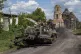 Ukrainian servicemen ride atop on armoured vehicle at the Ru