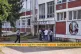 Police officers stand in front of a secondary school buildin