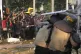 Student protesters confront riot police officers after teari