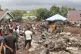 Rescuers and villagers search for missing people following a