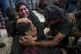 Palestinians mourn their relatives killed in the Israeli bom