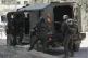 Members of Israeli forces prepare to enter in an armoured ve