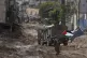 A man waves a Palestinian flag as he walks past an Israeli a