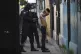 A police officer searches a man in the Kiwanis Community dur