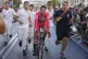 Primoz Roglic of Slovenia cycles to the podium as team membe