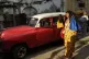 A woman walks with two dolls representing Cuba's patron sain
