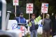 Boeing Machinists Union members wave to passing traffic whil
