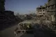 Israeli soldiers move next to buildings destroyed by the Isr