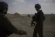 Israeli soldiers take up positions next to the Philadelphi C