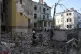 Rescuers search for victims in an apartment building destroy