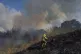 A firefighter works in the area around a fire after the mili