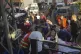 Civil Defence first-responders carry a man who was wounded a