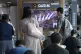 A TV screen shows a file image of North Korea's missiles lau