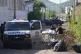Forensic investigators remove a body from the street in La C