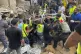 Rescuers carry a body at the scene of a missile strike in th