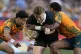 New Zealand's Jordie Barrett (centre) breaks the tackles of 