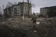 A Ukrainian marine serviceman runs to take a position throug