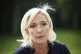 French far-right leader Marine Le Pen answers reporters at t