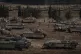 Israeli soldiers work on tanks and armoured personnel carrie