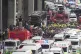 Rescuers gather at the site of a bus that caught fire, carry