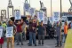 Longshoremen carry signs and chant, October 1, 2024, outside