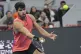 Carlos Alcaraz of Spain plays a forehand return against Jann