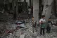 Palestinians examine a destroyed mosque following an Israeli