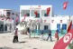 Tunisians walk to a polling station to cast their votes duri