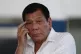 Rodrigo Duterte listens to a question from reporters at Mani