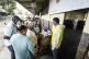 People queue to cast their votes during general elections in