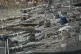 Israeli soldiers work on tanks in a staging area in northern
