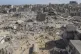 Palestinians walk through the destruction left by the Israel