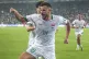 Iraq's Aymen Hussein celebrates with teammates after scoring