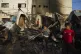 Palestinians look at the damage after an Israeli strike hit 