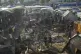 Palestinians look at the damage after an Israeli strike hit 