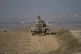 Israeli Defence Forces soldiers work on their tank near the 