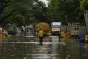 People wade through flooded street after heavy rains in Chen
