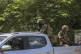 Soldiers patrol amid the sound of gunshots heard in the dist