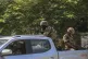 Soldiers patrol amid the sound of gunshots heard in the dist