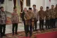 Indonesia's new President Prabowo Subianto (centre) announce