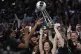 The New York Liberty hold up the championship trophy after d