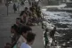 Residents pass the time at the Malecon during a blackout fol