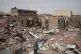 A man walks by a house hit in recent fighting in Khartoum, S