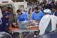 Paramedics and volunteers transport an injured victim of a b
